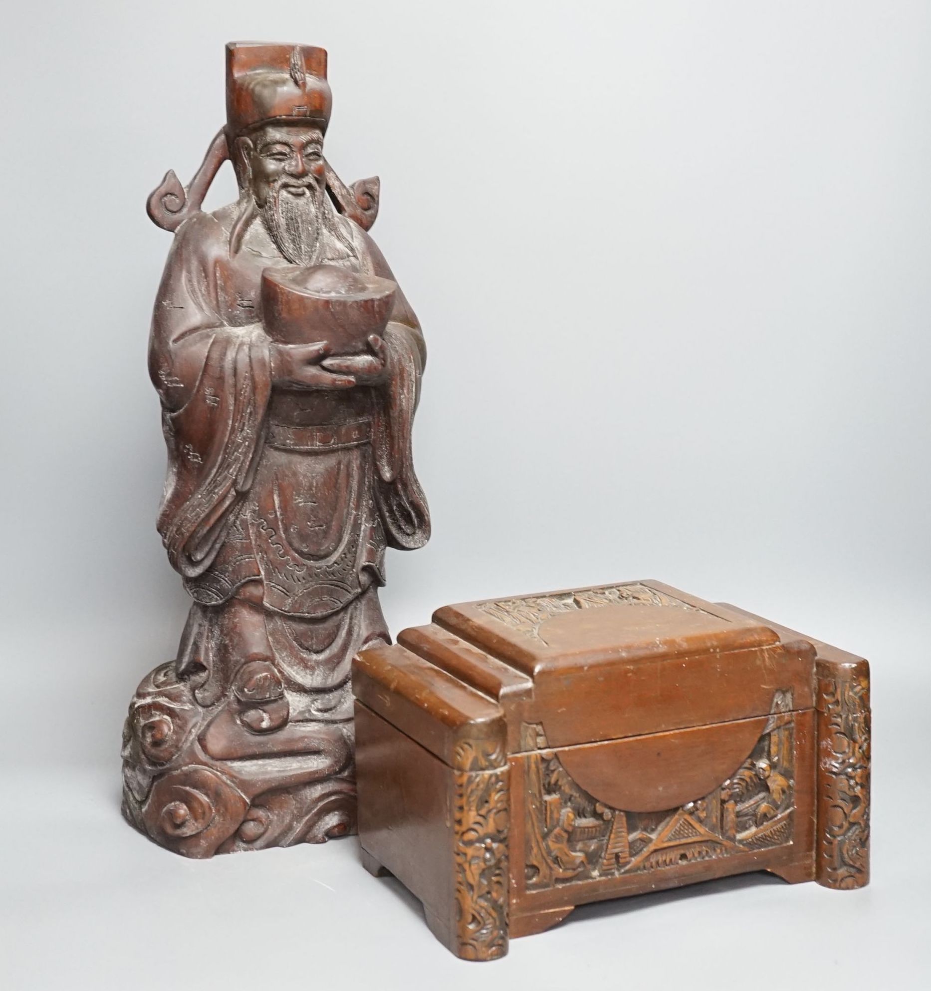 A Chinese carved wood sage and small carved trunk, Sage 47 cms high.